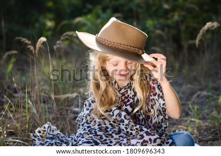 little adorable blond girl with cowboy hat portrait