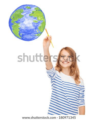 education, school and imaginary screen concept - cute little girl drawing with brush planet earth