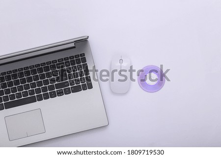 Laptop, Pc mouse with cd on white background. Top view