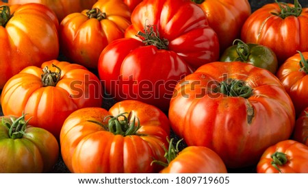 Ripe Beefsteak Tomatoes on rustic black table