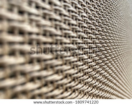 close up selective focus on middle brown cream speaker grill look Like woven bamboo with Blur the edges can use for background, backdrop and texture with copy space for letter. Side view angle.