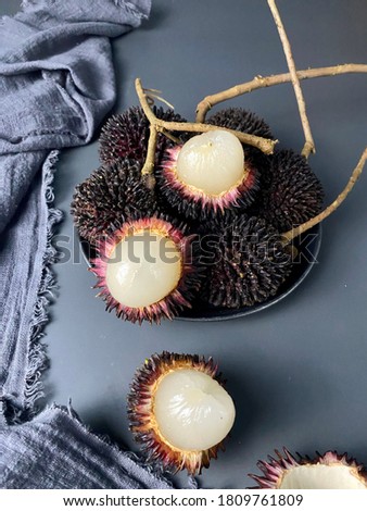 The pulasan, Nephelium mutabile Blume, is a tropical fruit closely allied to the rambutan and sometimes confused with it.