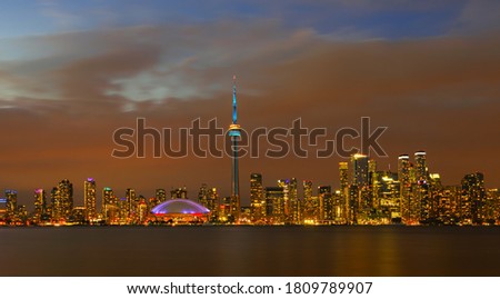Stunning illuminated  Toronto Downtown skylines over Ontario Lake at twilight, Toronto, Canada