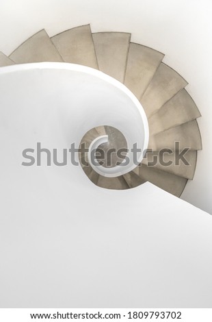 White concrete downward spinning staircase