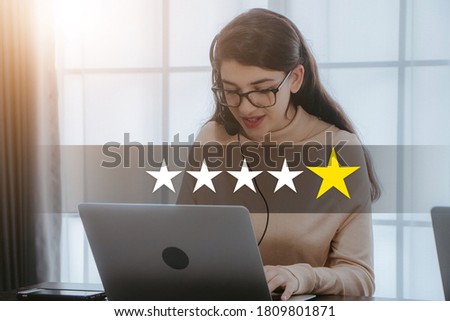 Beautiful young woman using computer laptop reviews rating with Five Star.