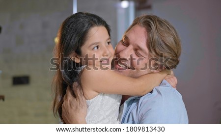Portrait of a father hugging his daughter with love. Father hugging and kissing his daughter. Father's Day concept.