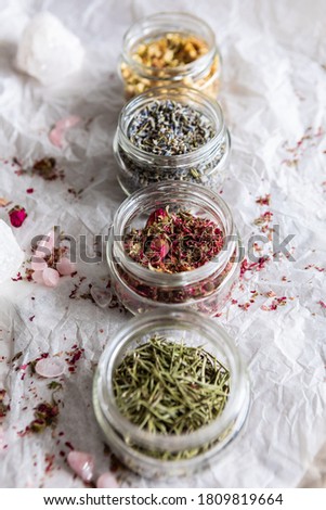 Jars with dried flowers, lavender and rosemary