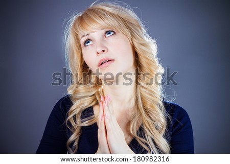 Closeup portrait of sad troubled, melancholic, funny looking young woman praying, hopes, asks, begs for best, having tough times in life isolated grey background. Emotion, facial expression, feeling
