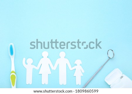 Family figures with toothbrush and mirror on blue background