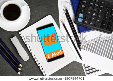 The businessman received an e-mail online.Online messages icon on  phone  on the businessman's Desk