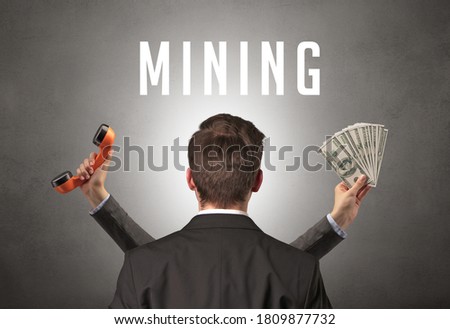 Rear view of a businessman with MINING inscription, cyber security concept