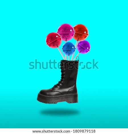 Contemporary art collage. Concept black boot with lollipops on a color background.