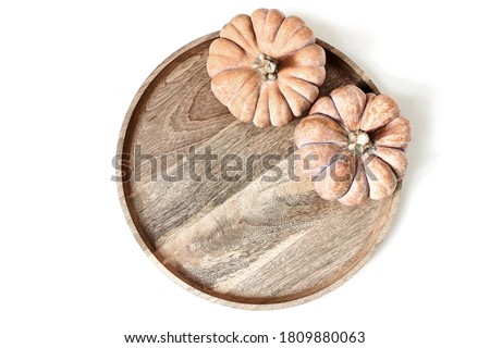Autumn composition. Orange pumpkins on wooden tray, plate  isolated on white table background. Fall, Halloween and Thanksgiving concept. Fall styled stock flat lay photography. Top view.