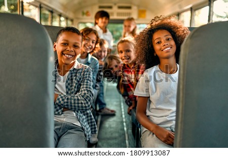 Back to school. Pupils of primary school in school bus. Happy children ready to study. Royalty-Free Stock Photo #1809913087