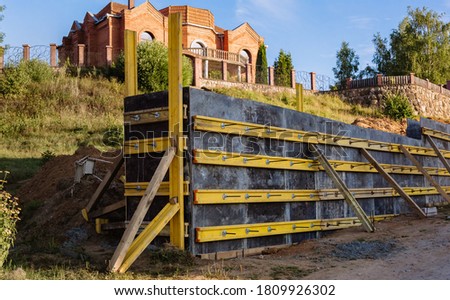 The construction of a retaining wall or counterfort, formwork, reinforced, preparation to pour concrete, construction site. Improvement of the territory. Preventive measures against landslide.