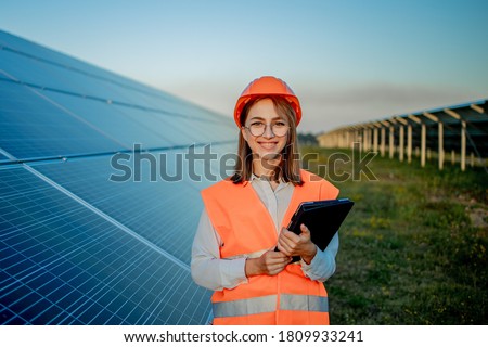 Inspector Engineer Woman Holding Digital Tablet Working in Solar Panels Power Farm, Photovoltaic Cell Park, Green Energy Concept. Royalty-Free Stock Photo #1809933241