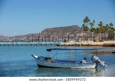 Day time view of a boat against the La Paz, Baja California Sur, Mexico, skyline.