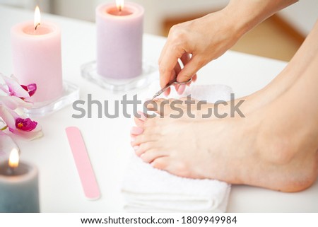 Young woman getting professional pedicure at home