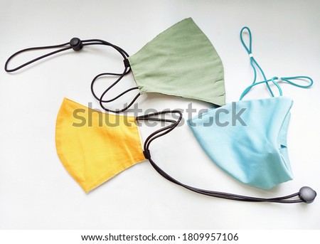 Photo of the washable two-layer cloth masks cotton and muslin with long ear and neck strap that can be adjusted to fit for wearing to protect against viruses when out in public, new normal. 