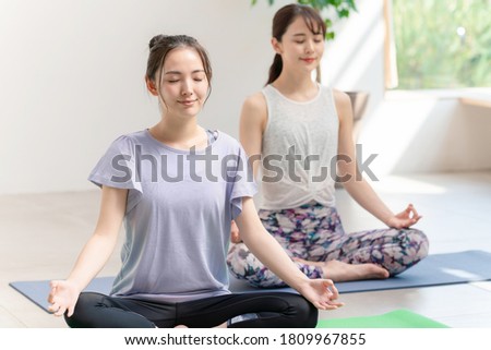 Young asian women doing yoga. Yoga instructor. Royalty-Free Stock Photo #1809967855