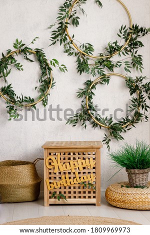 Birthday decorations - gifts, toys, garland and figure for little baby party on a white wall background.