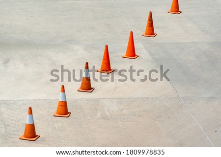 Traffic cone on concrete floor in parking lot