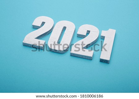 New year celebration White Wooden Numeral 2021 on Pastel blue background for Christmas or New Year