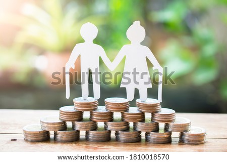 couple older model standing on money coins saving for concept investment mutual fund finance and pension retirement Royalty-Free Stock Photo #1810018570