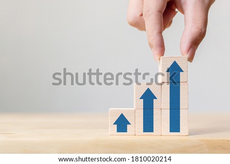 Ladder career path for business growth success process concept.Hand arranging wood block stacking as step stair with arrow up Royalty-Free Stock Photo #1810020214