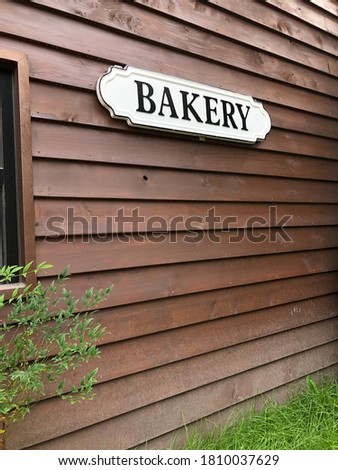 Bakery signboard on the wooden wall of the building.