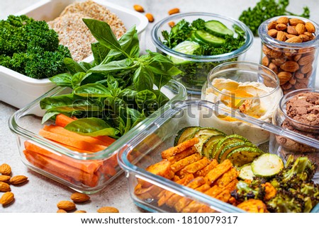 Preparing healthy meals for the week. Vegan food and snacks in containers, gray background. Flat lay cooking food. Royalty-Free Stock Photo #1810079317