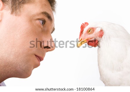 Face of man looking at chicken with calm expression on it