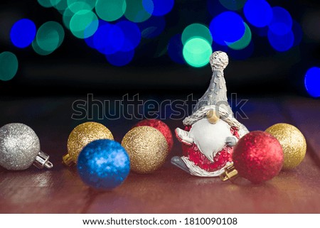 Christmas toys and Christmas gnome on a background of defocus lights