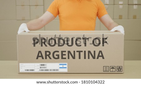 Warehouse worker and big box with PRODUCT OF ARGENTINA printed text