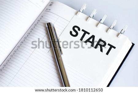 text START on the short note texture background with pen.Business concept