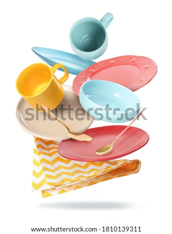 Set of clean tableware and napkin in flight on white background Royalty-Free Stock Photo #1810139311