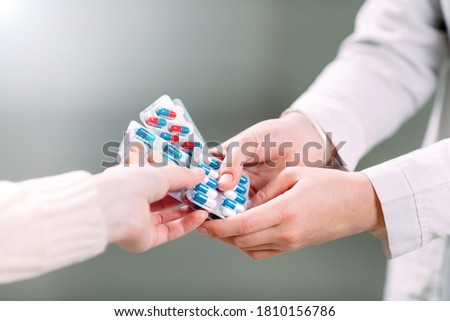Close up of a girl hands buying pills  in a pharmacy