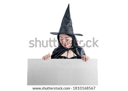 Asian witch woman with hat standing with empty whiteboard isolated over white background. Empty whiteboard for copy space
