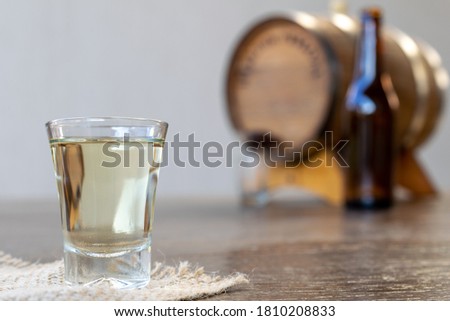 detail of white cachaça glass and vat and bottle on blurred background. September 13th is the national day of cachaça in Brazil Royalty-Free Stock Photo #1810208833