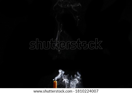close up on a candle with smoke isolated on black background with copy space for your text