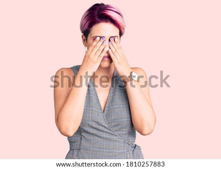 Young beautiful woman with pink hair wearing casual clothes rubbing eyes for fatigue and headache, sleepy and tired expression. vision problem 