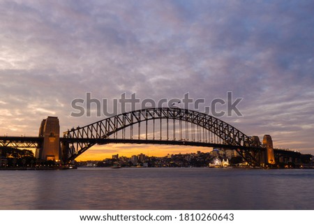 Cloudy dusk view over Sydney Harbour Bridge.