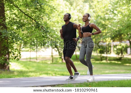 Morning Run. Sporty Black Guy And Girl Jogging Together In Green Park, Full-Length Shot With Free Space Royalty-Free Stock Photo #1810290961