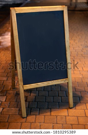 Vertical menu board at night on the street