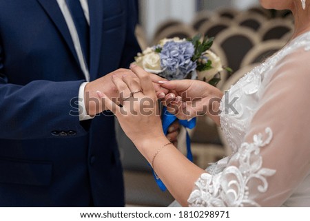 hands of the bride with a ring during the wedding in the registry office wedding ceremony