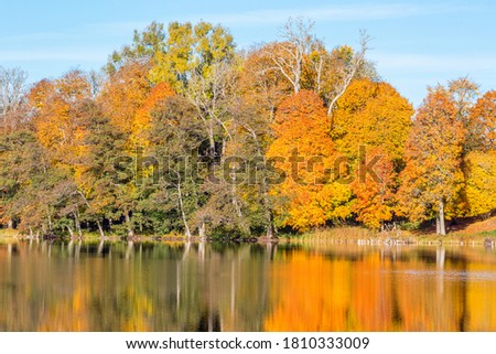 Lake with autumn colors on the trees reflecting in the water