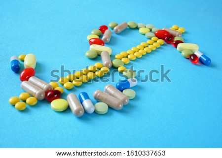 Dollar symbol from medicine pills, capsules, tablets. Treatment in coronavirus pandemic 
