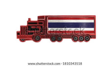 Toy truck with Thailand flag shown isolated on white background. The concept of cargo transportation between countries.