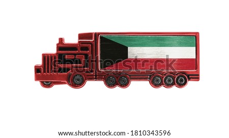 Toy truck with Kuwait flag shown isolated on white background. The concept of cargo transportation between countries.