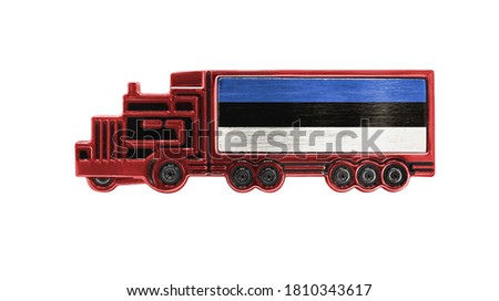 Toy truck with Estonia flag shown isolated on white background. The concept of cargo transportation between countries.